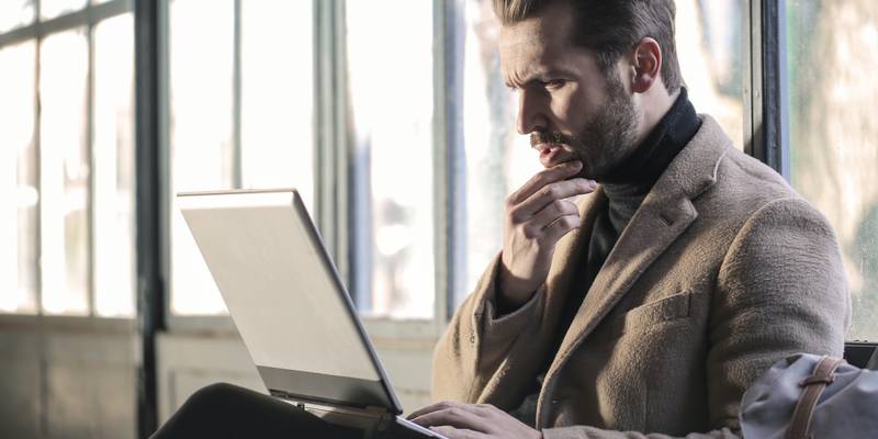 man-wearing-brown-jacket-and-using-grey-laptop-874242.jpg