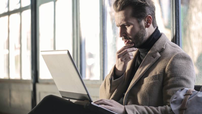 man-wearing-brown-jacket-and-using-grey-laptop-874242.jpg